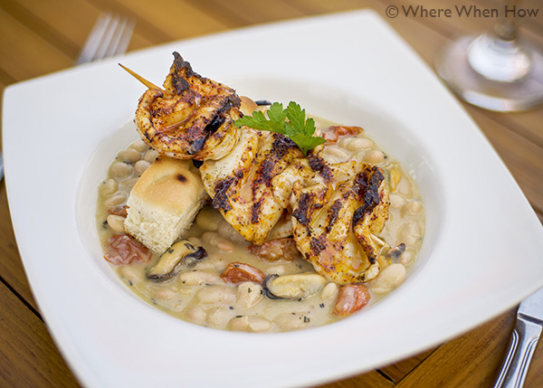 A photograph of Spiced Calamari Skewer Appetiser at Caicos Café on Governors Road, Providenciales (Provo), Turks and Caicos Islands.
