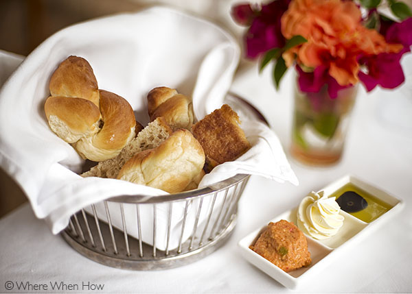 A photograph of Warm breads and crusty rolls served with various butter spreads. Grace’s Cottage, Grace Bay, Providenciales (Provo), Turks and Caicos Islands.