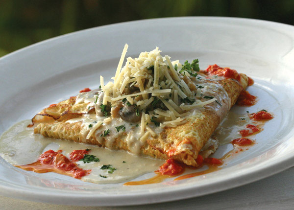 A photograph of the famous Conch Crepe appetizer at Bay Bistro on Grace Bay Beach, Providenciales (Provo), Turks and Caicos Islands.
