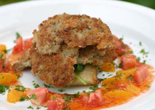 A photograph of Pecan Encrusted Conch with Orange Sauce at Bay Bistro on Grace Bay Beach, Providenciales (Provo), Turks and Caicos Islands.